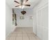 Bright living room featuring vaulted ceiling, modern ceiling fan and neutral tile flooring at 2449 E Lake Dr, Deland, FL 32724