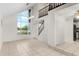 Bright living room with tile flooring and stairs at 2449 E Lake Dr, Deland, FL 32724