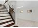 Bright living room featuring tile floors, a staircase, and elegant light fixtures at 2449 E Lake Dr, Deland, FL 32724