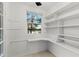 Pantry with window, built in desk and shelving at 2449 E Lake Dr, Deland, FL 32724