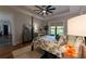 This primary bedroom features hardwood floors, a ceiling fan, tray ceilings and views of the backyard at 25879 Crossings Bluff Ln, Sorrento, FL 32776