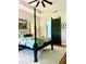 A bedroom showcases a four-poster bed and a stylish barn door at 25879 Crossings Bluff Ln, Sorrento, FL 32776