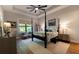 This primary bedroom features a tray ceiling, ceiling fan, hardwood floors and lots of natural light at 25879 Crossings Bluff Ln, Sorrento, FL 32776