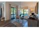 Cozy breakfast nook boasts wood floors, modern chandelier, outdoor living area access, and serving bar at 25879 Crossings Bluff Ln, Sorrento, FL 32776