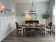 Inviting dining room featuring a decorative chandelier, wall paneling and seating for six at 25879 Crossings Bluff Ln, Sorrento, FL 32776
