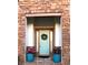 Inviting entryway with a light blue front door, flanked by stone accents and beautiful potted plants at 25879 Crossings Bluff Ln, Sorrento, FL 32776