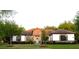Charming single-story home featuring a tile roof, stone accents, manicured lawn and mature landscaping at 25879 Crossings Bluff Ln, Sorrento, FL 32776