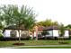 Charming single-story home featuring a tile roof, stone accents, manicured lawn and mature landscaping at 25879 Crossings Bluff Ln, Sorrento, FL 32776