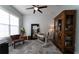 Comfortable home office with natural light, modern desk, vintage cabinet and accent furniture at 25879 Crossings Bluff Ln, Sorrento, FL 32776