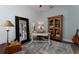 Well-lit home office featuring a large mirror, comfortable seating and hardwood floors at 25879 Crossings Bluff Ln, Sorrento, FL 32776
