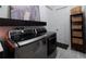 This modern laundry room features side by side washer and dryer and built in shelving at 25879 Crossings Bluff Ln, Sorrento, FL 32776