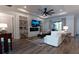 Bright living room featuring modern fireplace, built-in shelves, recessed lighting and hardwood floors at 25879 Crossings Bluff Ln, Sorrento, FL 32776