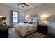 Comfortable bedroom with ceiling fan, wood floors, bedside tables, neutral colors, and modern decor at 25879 Crossings Bluff Ln, Sorrento, FL 32776