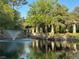 Scenic pond with a charming gazebo, water fountain, and lush green surroundings at 25879 Crossings Bluff Ln, Sorrento, FL 32776