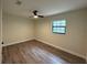 Bedroom showcasing wood-look flooring, ceiling fan, and natural light from the window at 303 E Fountain St, Fruitland Park, FL 34731