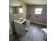 Bathroom with gray flooring, new sink and open cabinet at 309 Old Mission Rd, New Smyrna Beach, FL 32168