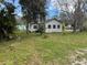 Exterior view of a house with an expansive green lawn at 309 Old Mission Rd, New Smyrna Beach, FL 32168