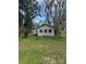 Lovely home exterior with well-manicured lawn and mature trees at 309 Old Mission Rd, New Smyrna Beach, FL 32168