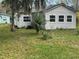Charming house exterior with mature trees and landscaping on a green lawn at 309 Old Mission Rd, New Smyrna Beach, FL 32168