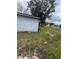 An exterior view showcasing the side of the home and surrounding grounds at 309 Old Mission Rd, New Smyrna Beach, FL 32168