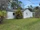 Side exterior of home showcasing palm tree at 309 Old Mission Rd, New Smyrna Beach, FL 32168