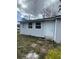 Exterior view of a small house with white siding and a white door at 309 Old Mission Rd, New Smyrna Beach, FL 32168