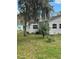 Charming house exterior surrounded by mature trees and a neat yard at 309 Old Mission Rd, New Smyrna Beach, FL 32168
