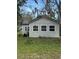 A cozy home exterior featuring a neatly kept lawn and ample windows at 309 Old Mission Rd, New Smyrna Beach, FL 32168