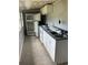 Interior view of a kitchen with white appliances and cabinets at 309 Old Mission Rd, New Smyrna Beach, FL 32168