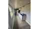Interior view of a narrow kitchen with gray walls and undermount sink at 309 Old Mission Rd, New Smyrna Beach, FL 32168