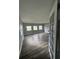 This living room has multiple windows providing natural light and modern wood-look flooring at 309 Old Mission Rd, New Smyrna Beach, FL 32168