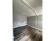 Compact room with wood-look flooring, plain walls, and a simple ceiling at 309 Old Mission Rd, New Smyrna Beach, FL 32168