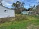 Backyard shot featuring an overgrown yard and another house at 309 Old Mission Rd, New Smyrna Beach, FL 32168
