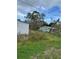 Backyard shot featuring an overgrown yard and another house at 309 Old Mission Rd, New Smyrna Beach, FL 32168