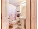 Bathroom featuring a pedestal sink, tile floors, and floral shower curtain at 3215 Roscoe Ave, Lakeland, FL 33803