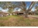 Beautiful home exterior featuring a well-manicured lawn and mature trees at 3215 Roscoe Ave, Lakeland, FL 33803