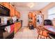 Functional kitchen with wooden cabinets, tile flooring, and modern appliances at 3215 Roscoe Ave, Lakeland, FL 33803