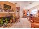 Open-concept living area with a brick fireplace and tile flooring at 3215 Roscoe Ave, Lakeland, FL 33803