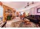 Cozy living room featuring a brick fireplace, tile flooring, and comfortable leather seating at 3215 Roscoe Ave, Lakeland, FL 33803