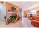 Open-concept living area with a brick fireplace and tile flooring at 3215 Roscoe Ave, Lakeland, FL 33803