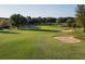 Beautiful golf course featuring pristine green fairways, mature trees, and strategically placed sand bunkers at 3623 Eversholt St, Clermont, FL 34711