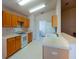 Bright kitchen with wooden cabinets and white appliances at 3623 Eversholt St, Clermont, FL 34711