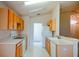 Well-lit kitchen features wooden cabinets, white appliances, and a bright interior at 3623 Eversholt St, Clermont, FL 34711
