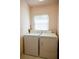 Efficient laundry room with a standard washer, dryer, and a bright window at 3623 Eversholt St, Clermont, FL 34711