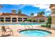 Community pool and hot tub with lounge chairs and lush landscaping at 3623 Eversholt St, Clermont, FL 34711
