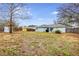 Large backyard with a patio area for entertaining, complemented by mature trees and a storage shed at 402 Bramble Way, Minneola, FL 34715