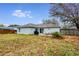 Spacious backyard featuring a patio with outdoor seating, a grill, and a well-maintained lawn enclosed by a wooden fence at 402 Bramble Way, Minneola, FL 34715