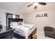 Cozy bedroom features a comfortable bed, dark trim and plenty of natural light at 402 Bramble Way, Minneola, FL 34715