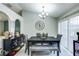Dining area with a contemporary table set, chandelier, and sliding doors for natural light, plus modern decor at 402 Bramble Way, Minneola, FL 34715