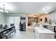 Open-concept kitchen and dining area with modern appliances, white cabinets, and seamless flow for entertaining at 402 Bramble Way, Minneola, FL 34715
